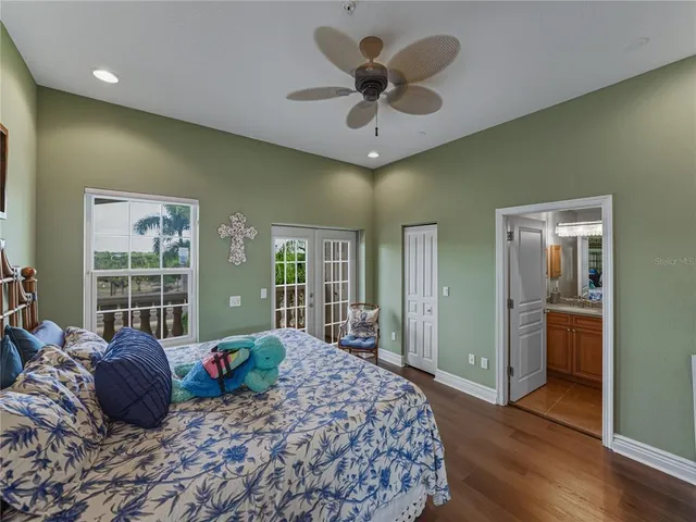 a large bedroom with a large bed and a large window