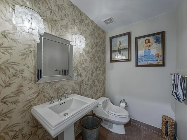 a bathroom with a sink toilet and mirror