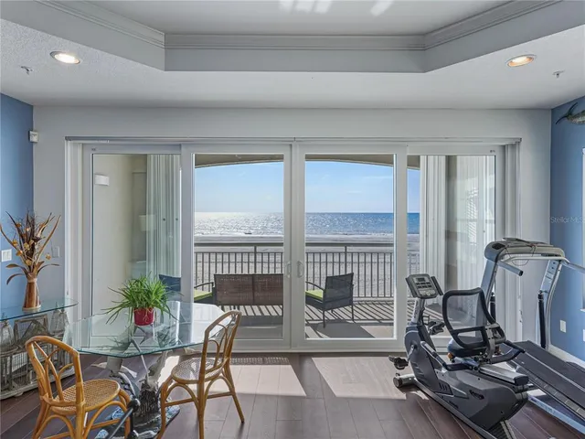 a view of a livingroom with furniture and floor to ceiling window