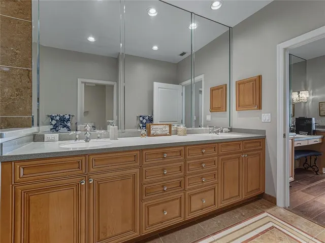 a bathroom with double vanity sinks and a large mirror