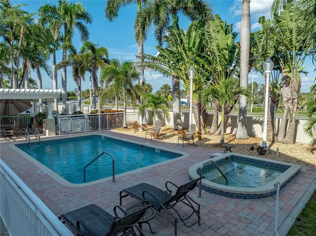 an outdoor space with swimming pool and furniture