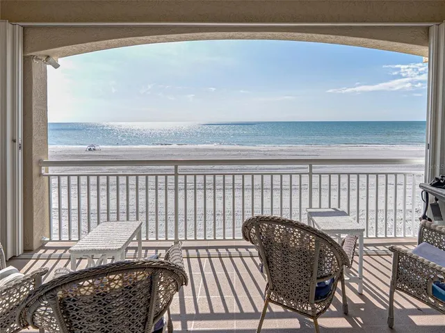 a balcony view with a chair and table