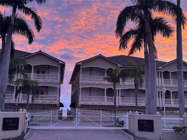 front view of a house with a palm tree