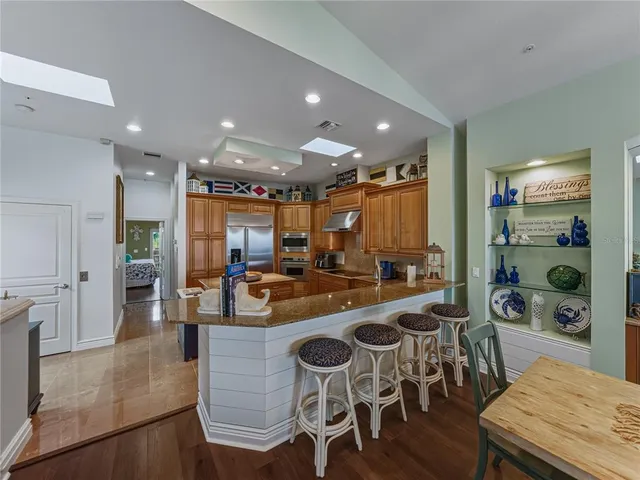 a large kitchen with a table and chairs