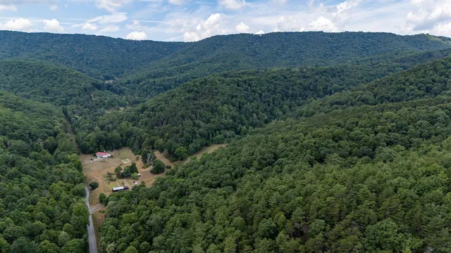 a view of a mountain range with lush green forest