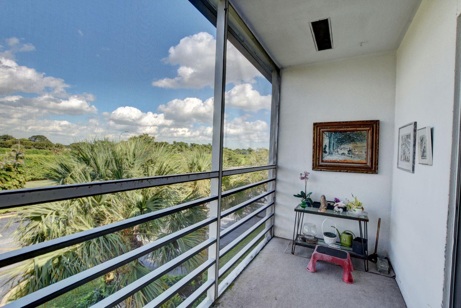 246 Suffolk F Boca Raton, FL 33434 - Photo 15 of 15 a view of a porch with furniture and floor to ceiling window