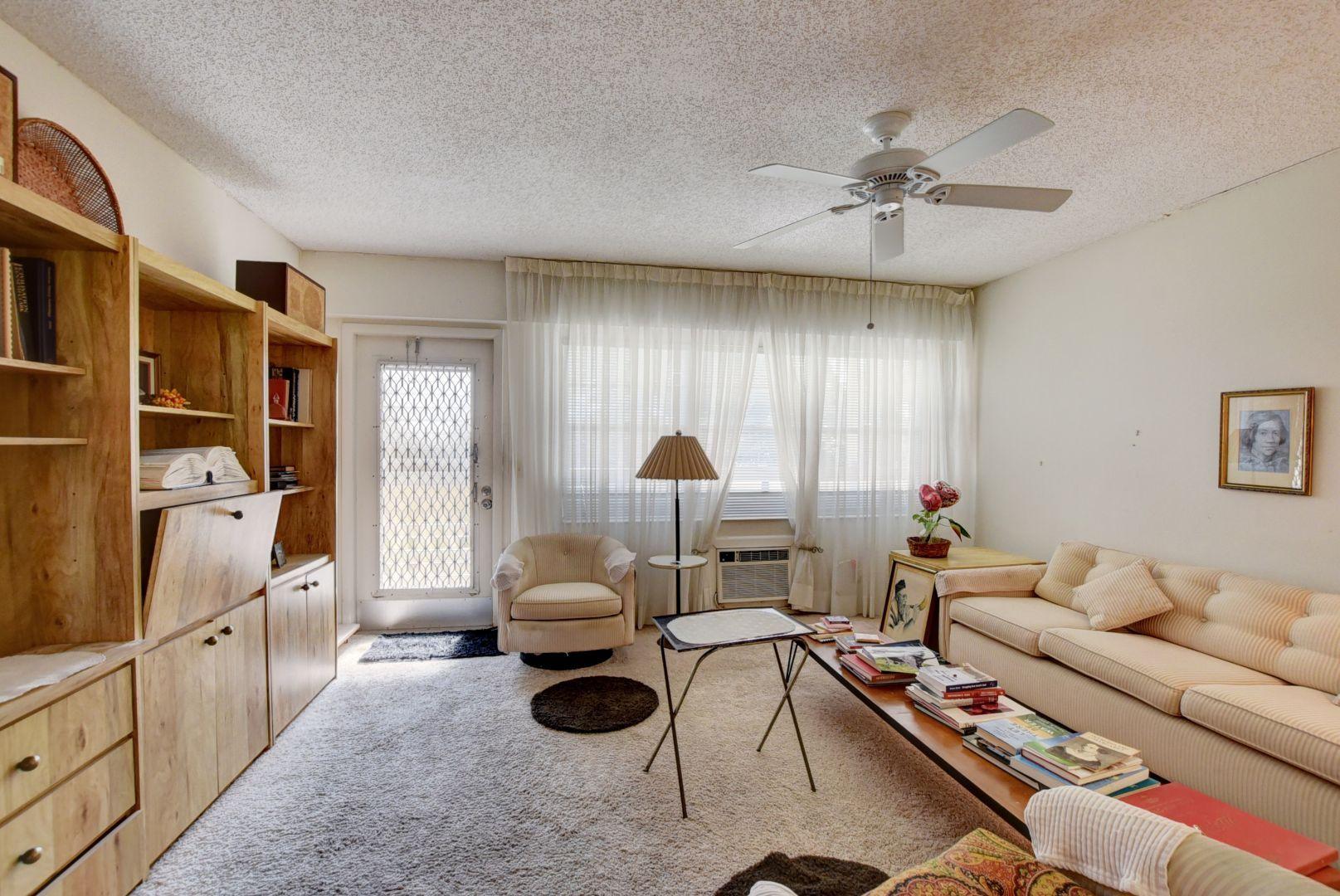 246 Suffolk F Boca Raton, FL 33434 - Photo 7 of 15 a living room with furniture and a chandelier