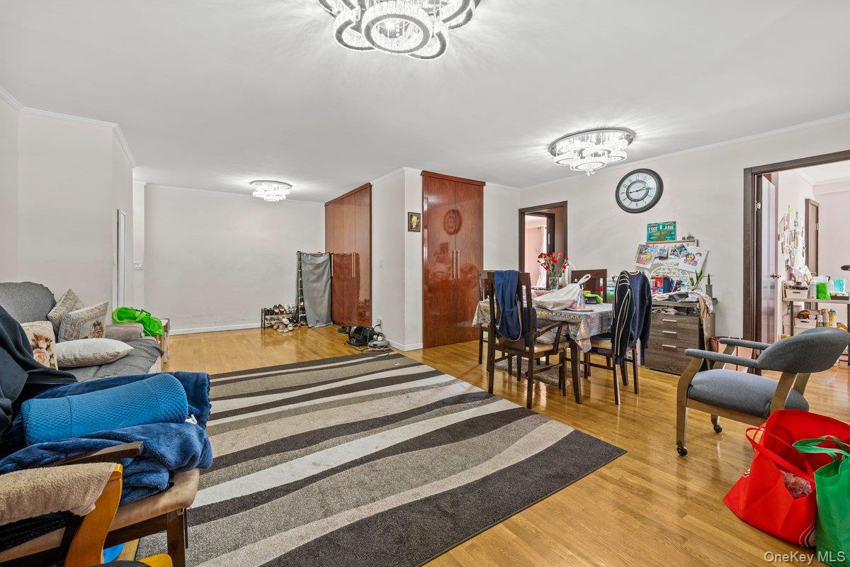 6135 98th Street, Unit 8D Queens, NY 11374 - Photo 12 of 17 a spacious bedroom with a bed and a table in it