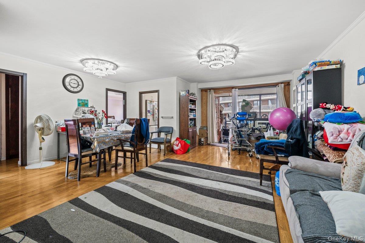 6135 98th Street, Unit 8D Queens, NY 11374 - Photo 14 of 17 a living room with furniture a rug and a flat screen tv