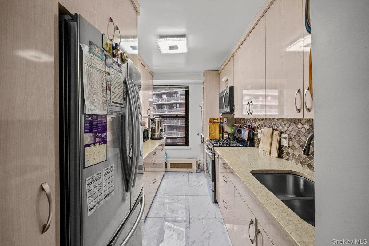6135 98th Street, Unit 8D Queens, NY 11374 - Photo 7 of 17 a kitchen with stainless steel appliances granite countertop a refrigerator and a sink