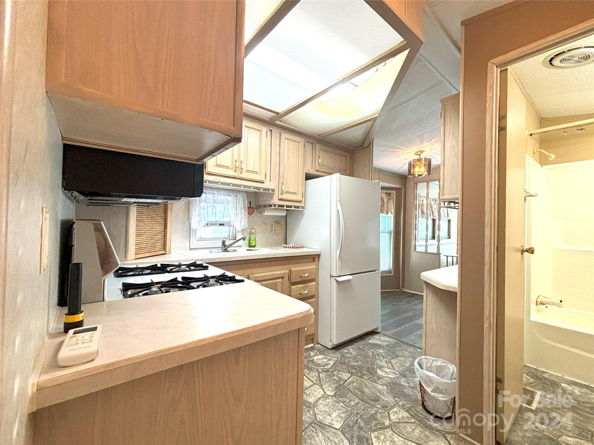 306 Mallard Loop Waynesville, NC 28785 - Photo 13 of 34 a kitchen with a refrigerator and a stove
