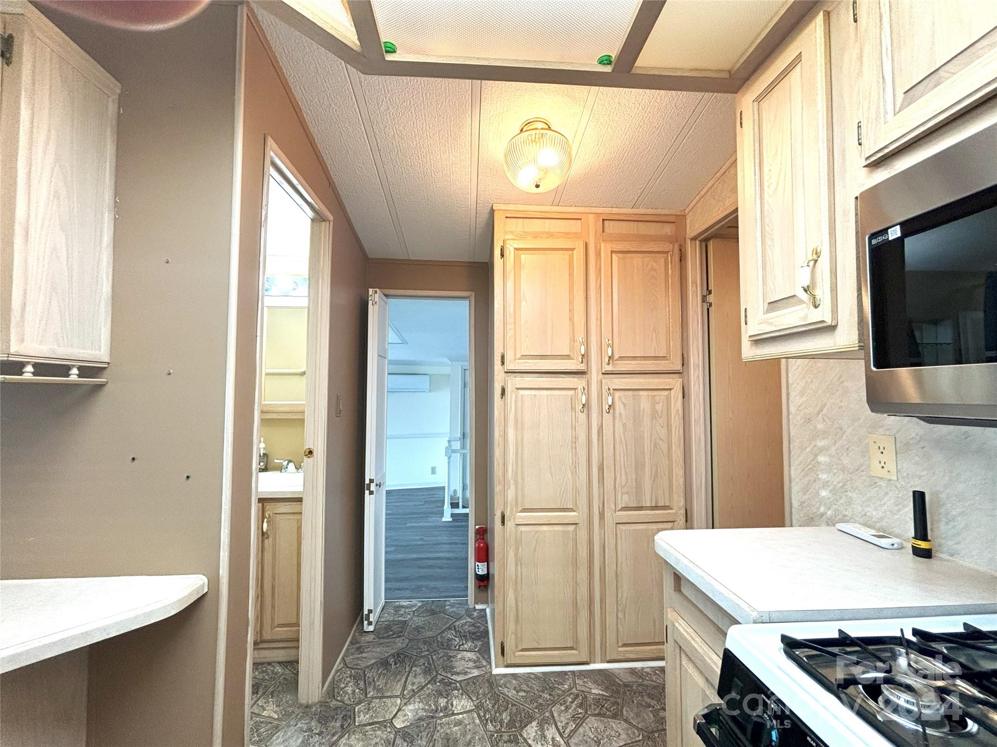306 Mallard Loop Waynesville, NC 28785 - Photo 15 of 34 a kitchen that has a stove a refrigerator and a sink