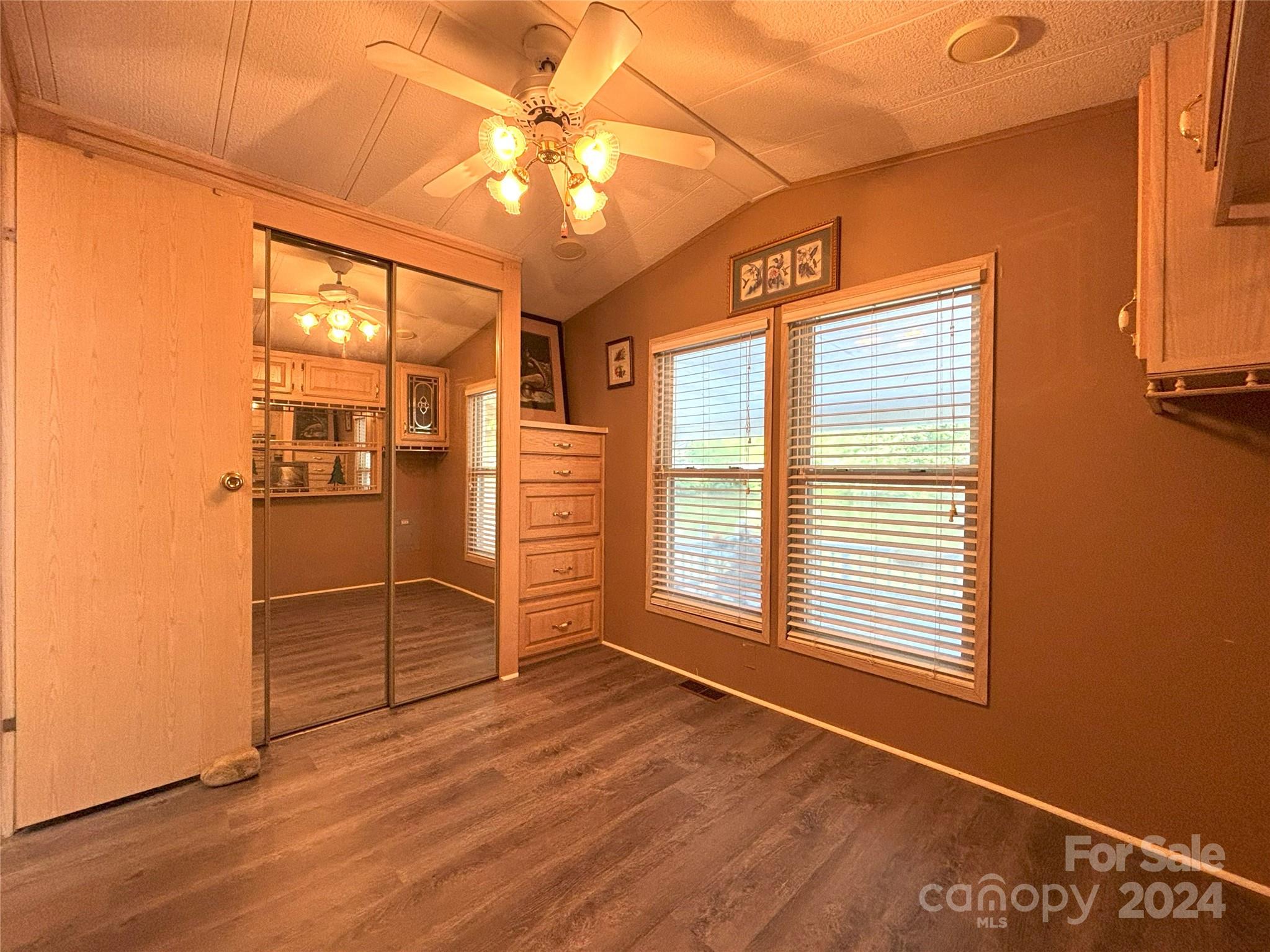 306 Mallard Loop Waynesville, NC 28785 - Photo 17 of 34 an empty room with wooden floor and windows