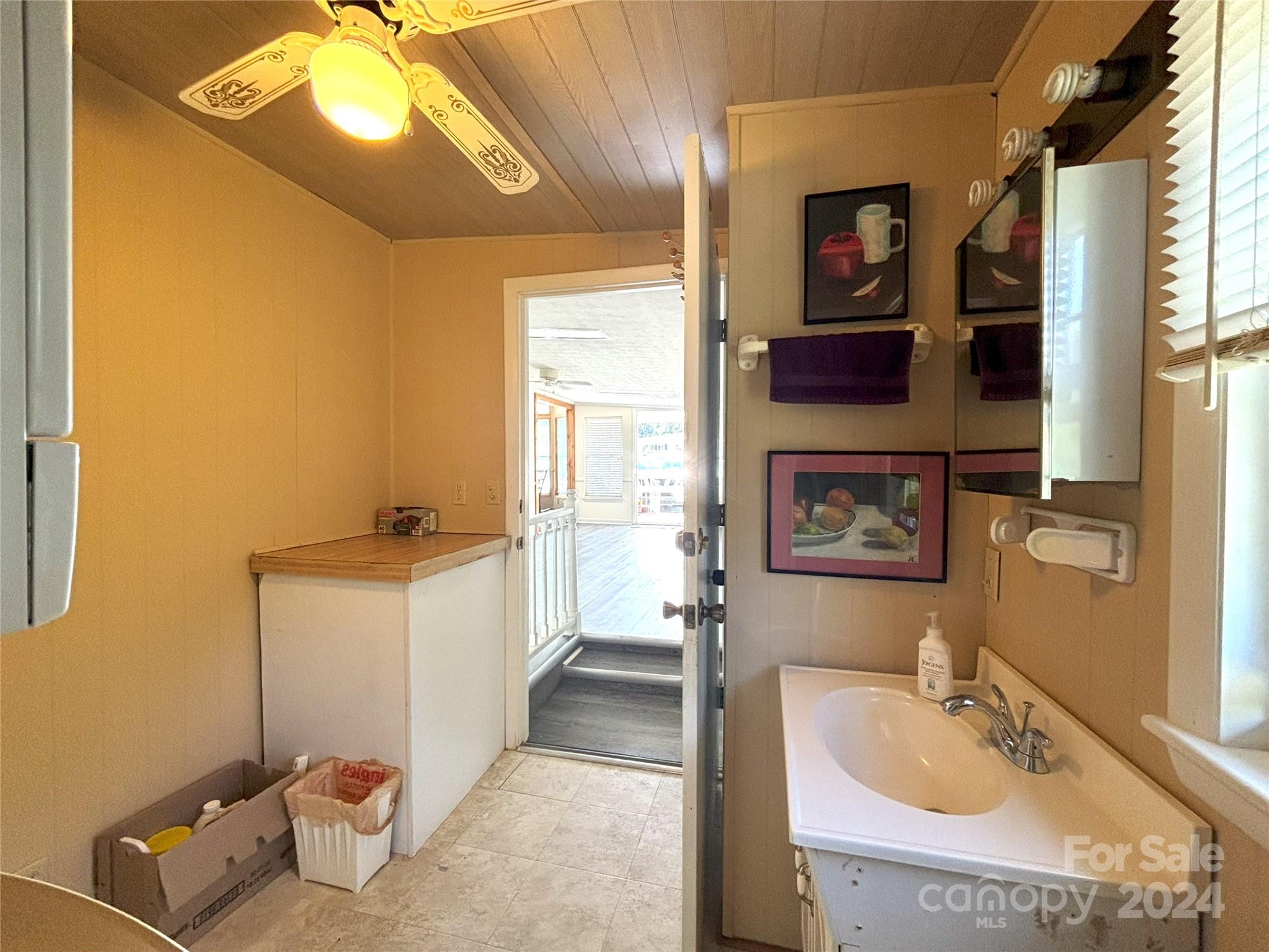 306 Mallard Loop Waynesville, NC 28785 - Photo 22 of 34 a en suite bathroom with a sink and a mirror
