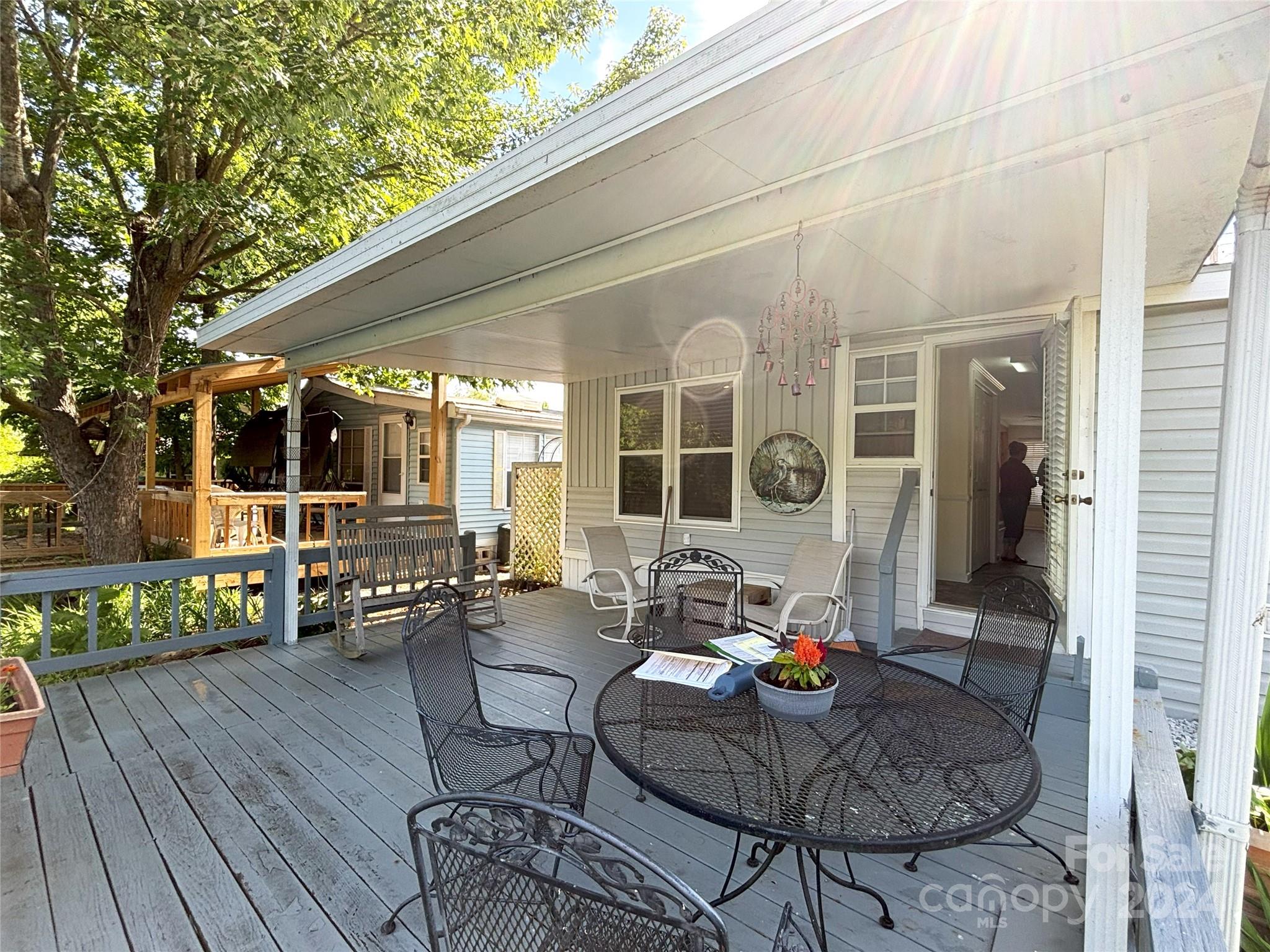 306 Mallard Loop Waynesville, NC 28785 - Photo 24 of 34 a outdoor space with patio the couches and a dining table with chairs