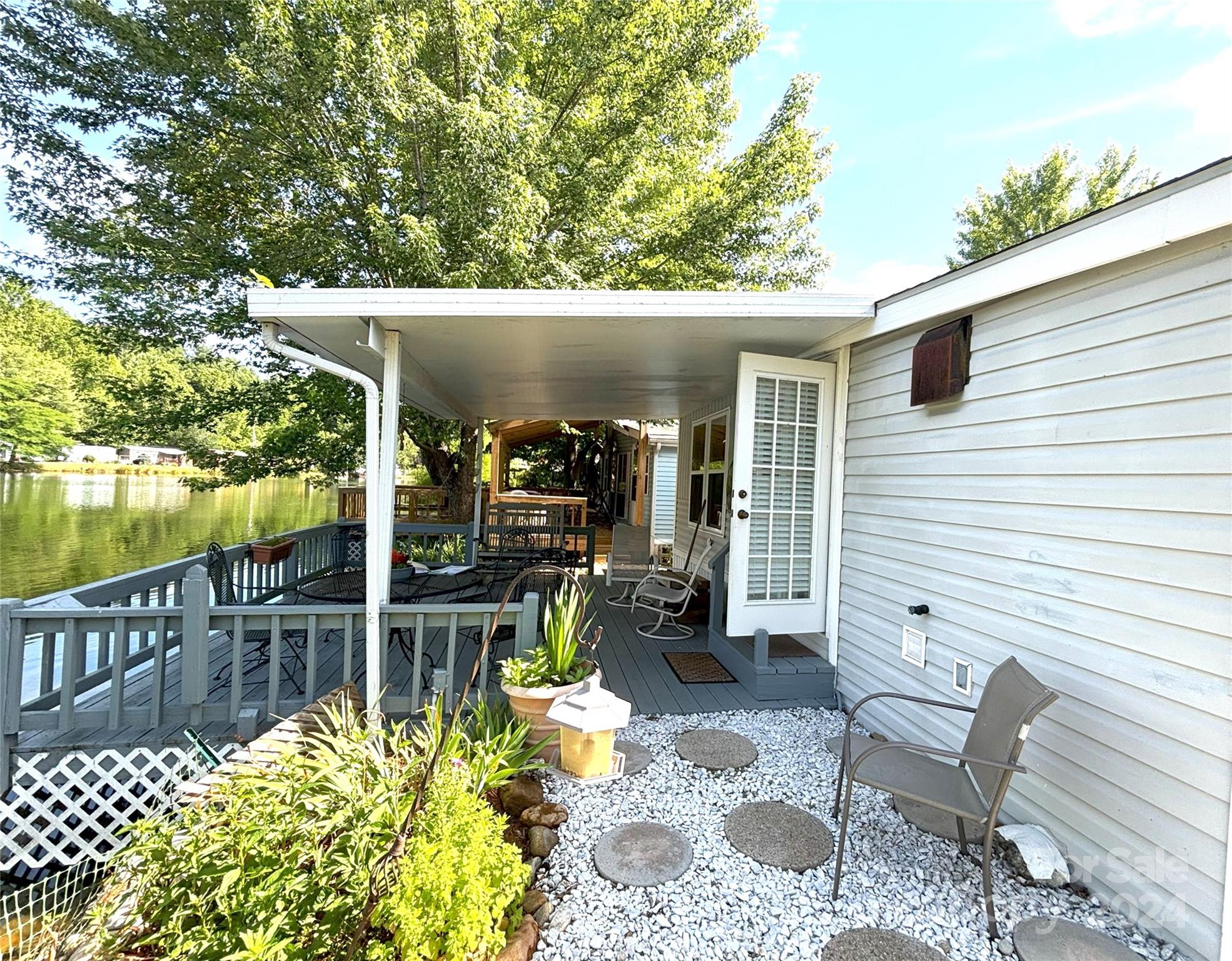 306 Mallard Loop Waynesville, NC 28785 - Photo 26 of 34 a view of a chairs and table in backyard of the house