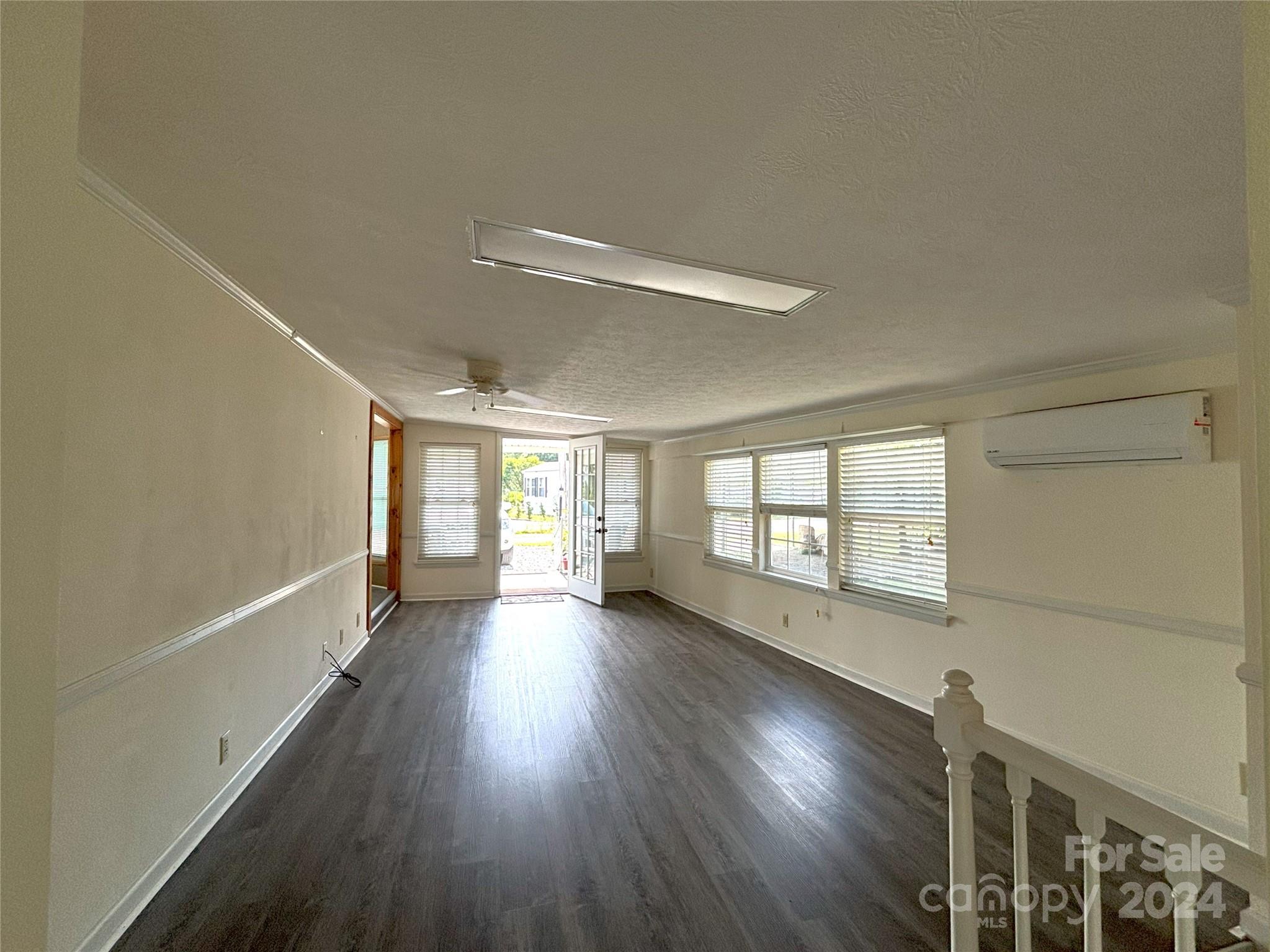 306 Mallard Loop Waynesville, NC 28785 - Photo 7 of 34 a view of an empty room with wooden floor and a window