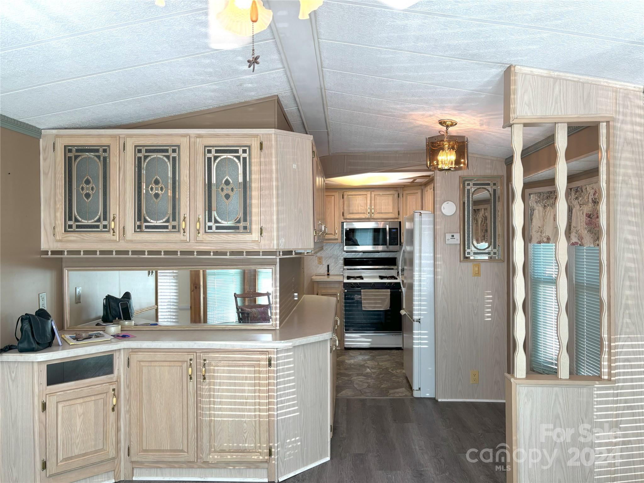 306 Mallard Loop Waynesville, NC 28785 - Photo 9 of 34 a kitchen with stainless steel appliances a refrigerator and cabinets