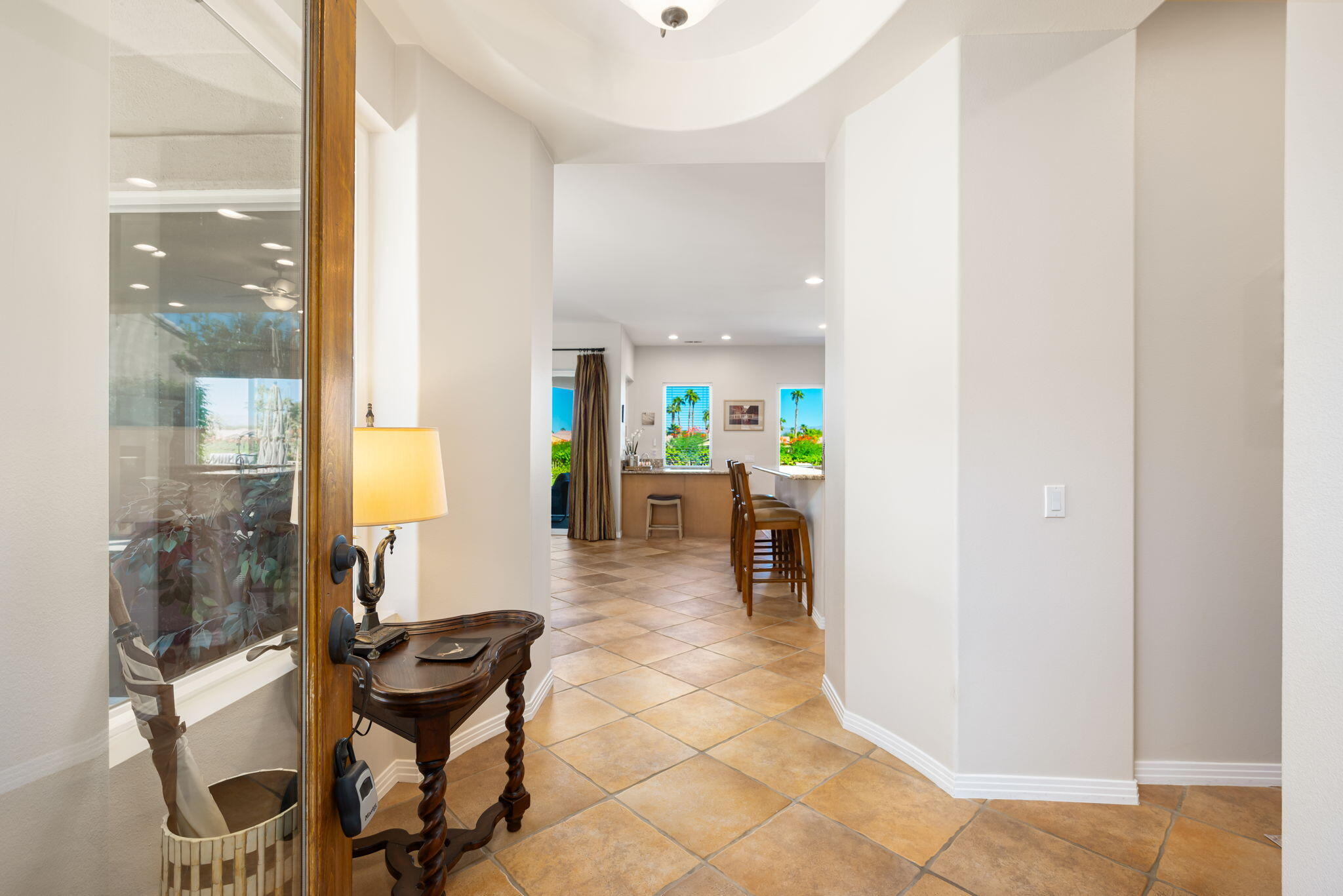 81260 Golf View Drive La Quinta, CA 92253 - Photo 11 of 58 a view of a hallway with dining area and glass windows