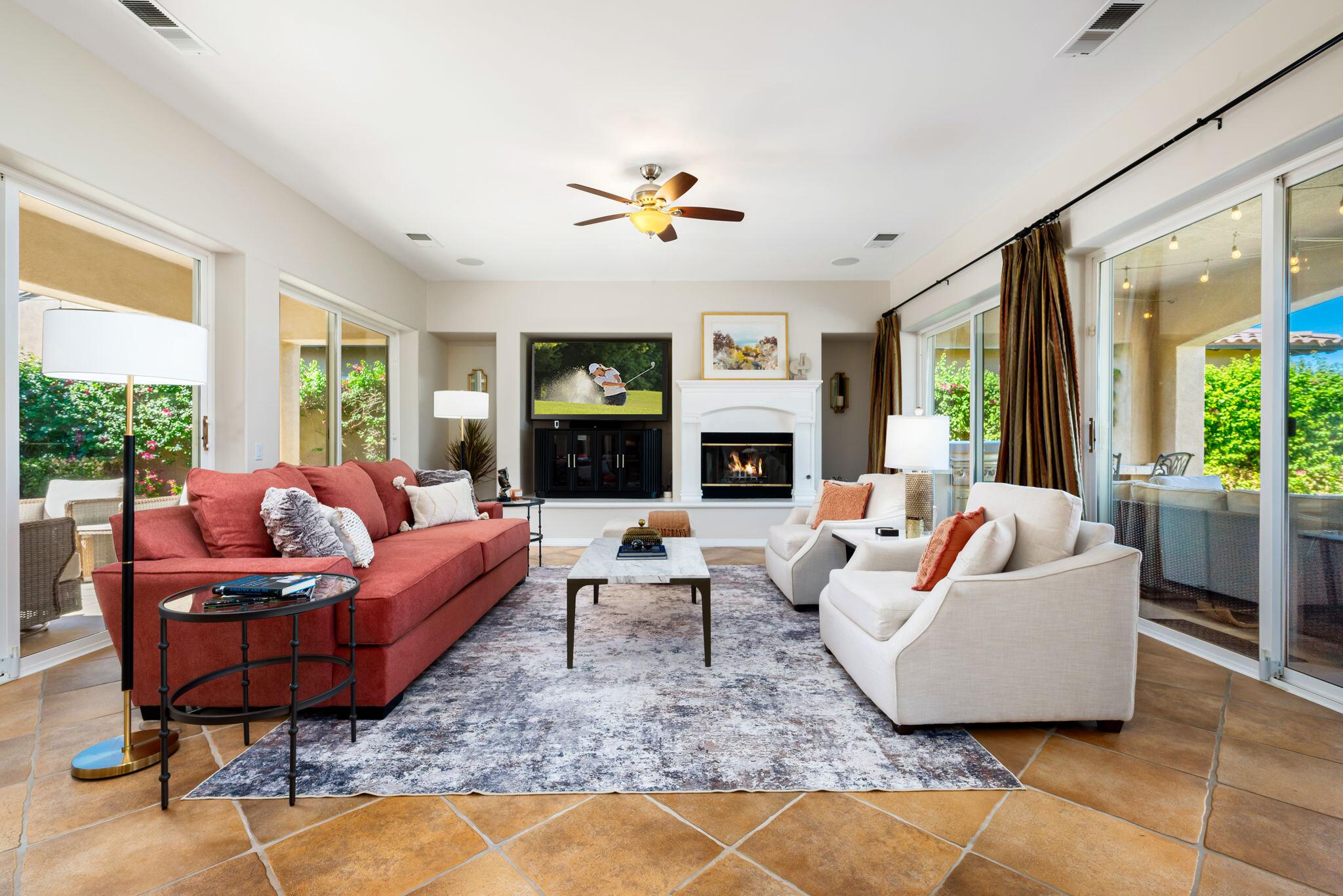 81260 Golf View Drive La Quinta, CA 92253 - Photo 12 of 58 a living room with furniture fireplace and a large window