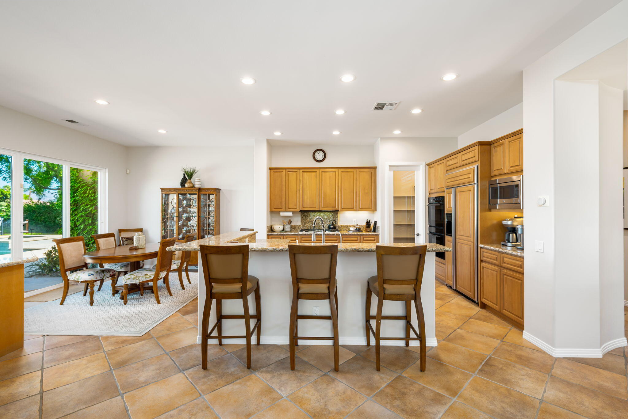 81260 Golf View Drive La Quinta, CA 92253 - Photo 15 of 58 a dining room with furniture and a kitchen