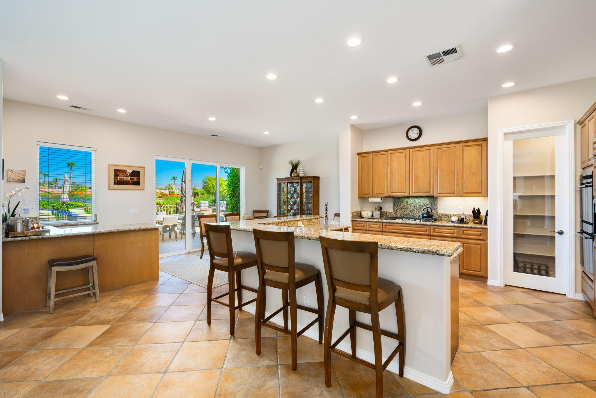 81260 Golf View Drive La Quinta, CA 92253 - Photo 16 of 58 a kitchen with stainless steel appliances granite countertop a table and chairs