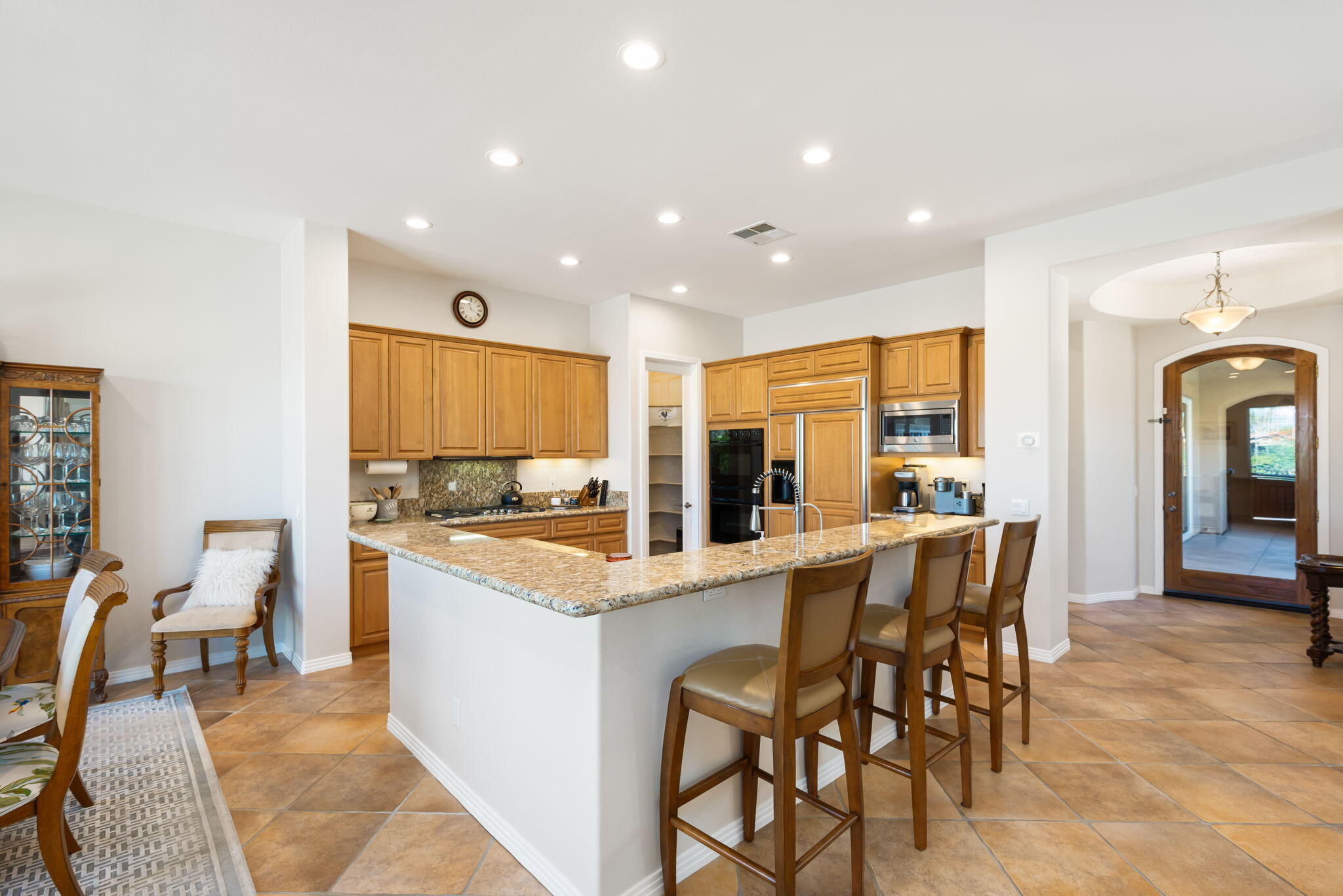 81260 Golf View Drive La Quinta, CA 92253 - Photo 17 of 58 a kitchen with a dining table chairs and white appliances