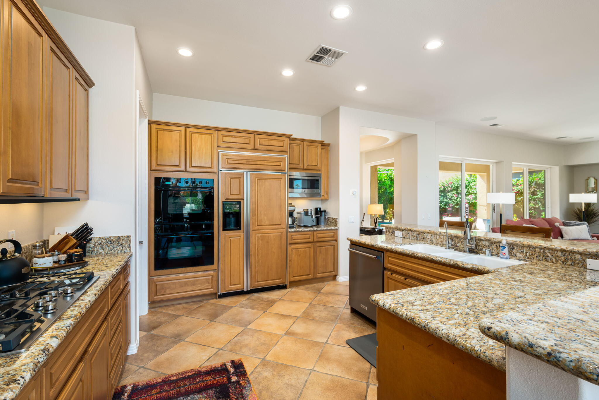 81260 Golf View Drive La Quinta, CA 92253 - Photo 20 of 58 a kitchen with stainless steel appliances granite countertop sink stove and refrigerator