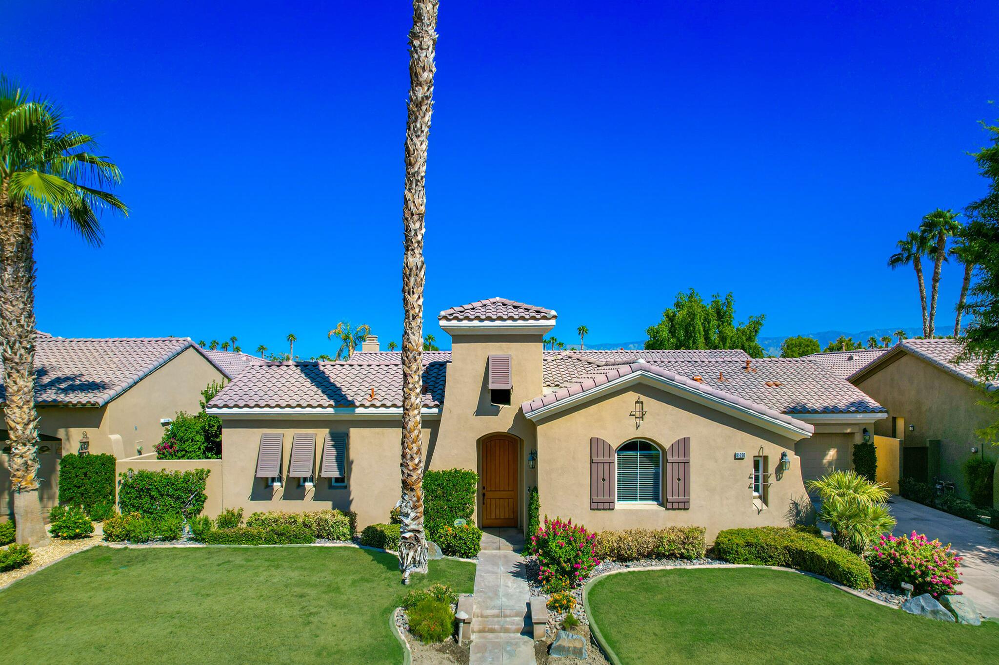 81260 Golf View Drive La Quinta, CA 92253 - Photo 4 of 58 a front view of a house with a garden