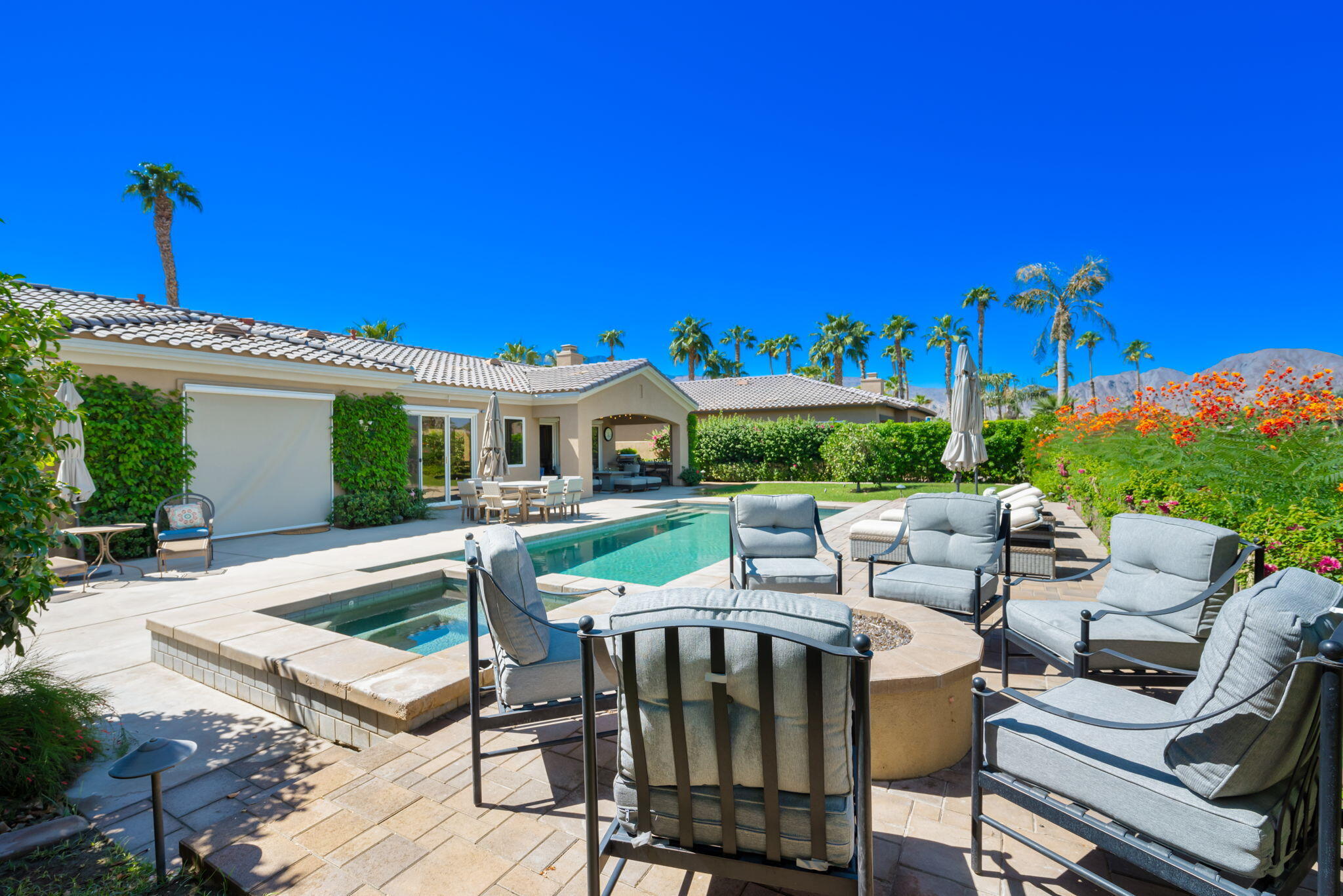 81260 Golf View Drive La Quinta, CA 92253 - Photo 41 of 58 a view of a patio with couches table and chairs under an umbrella