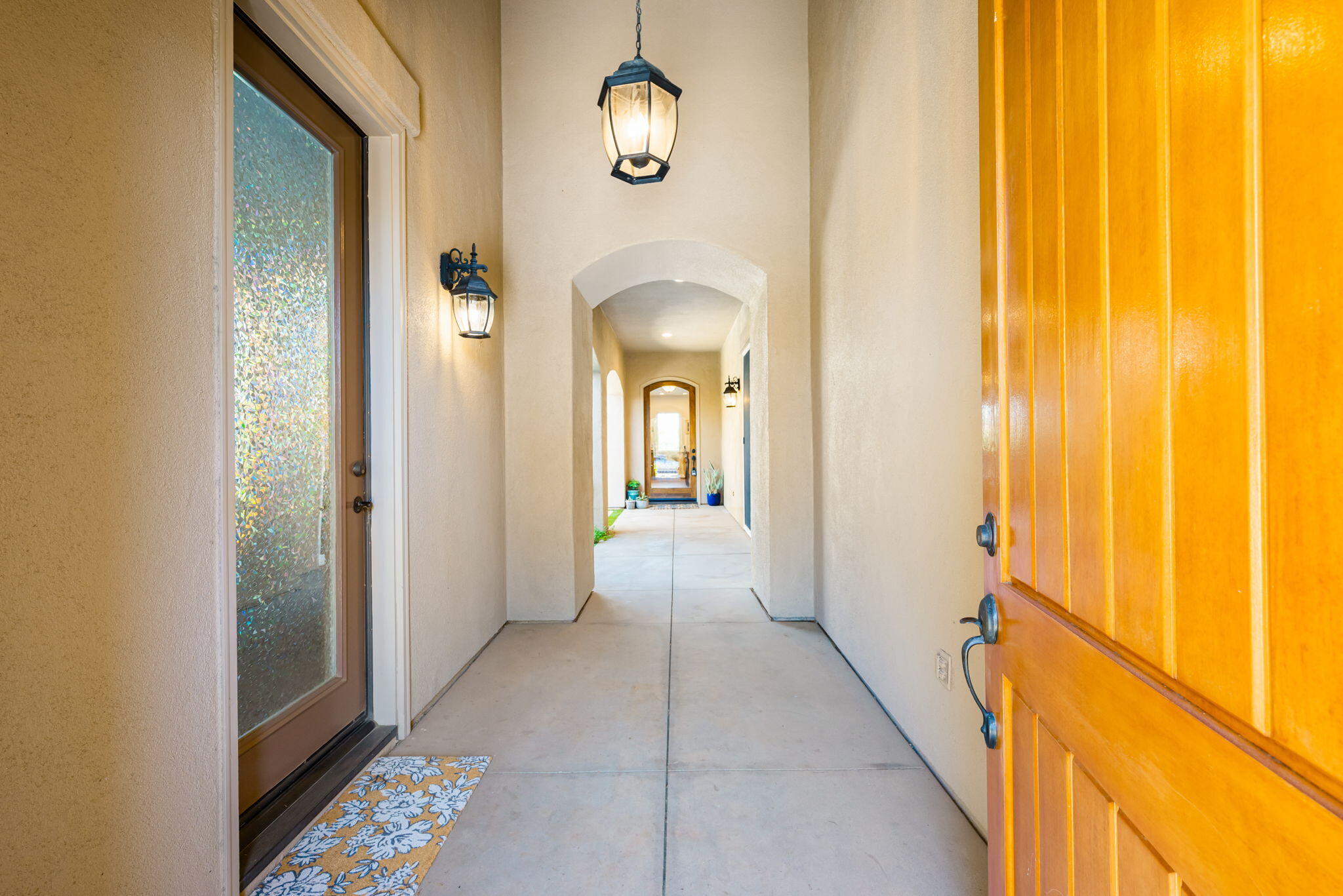 81260 Golf View Drive La Quinta, CA 92253 - Photo 5 of 58 a view of a hallway with wooden floor and a chandelier