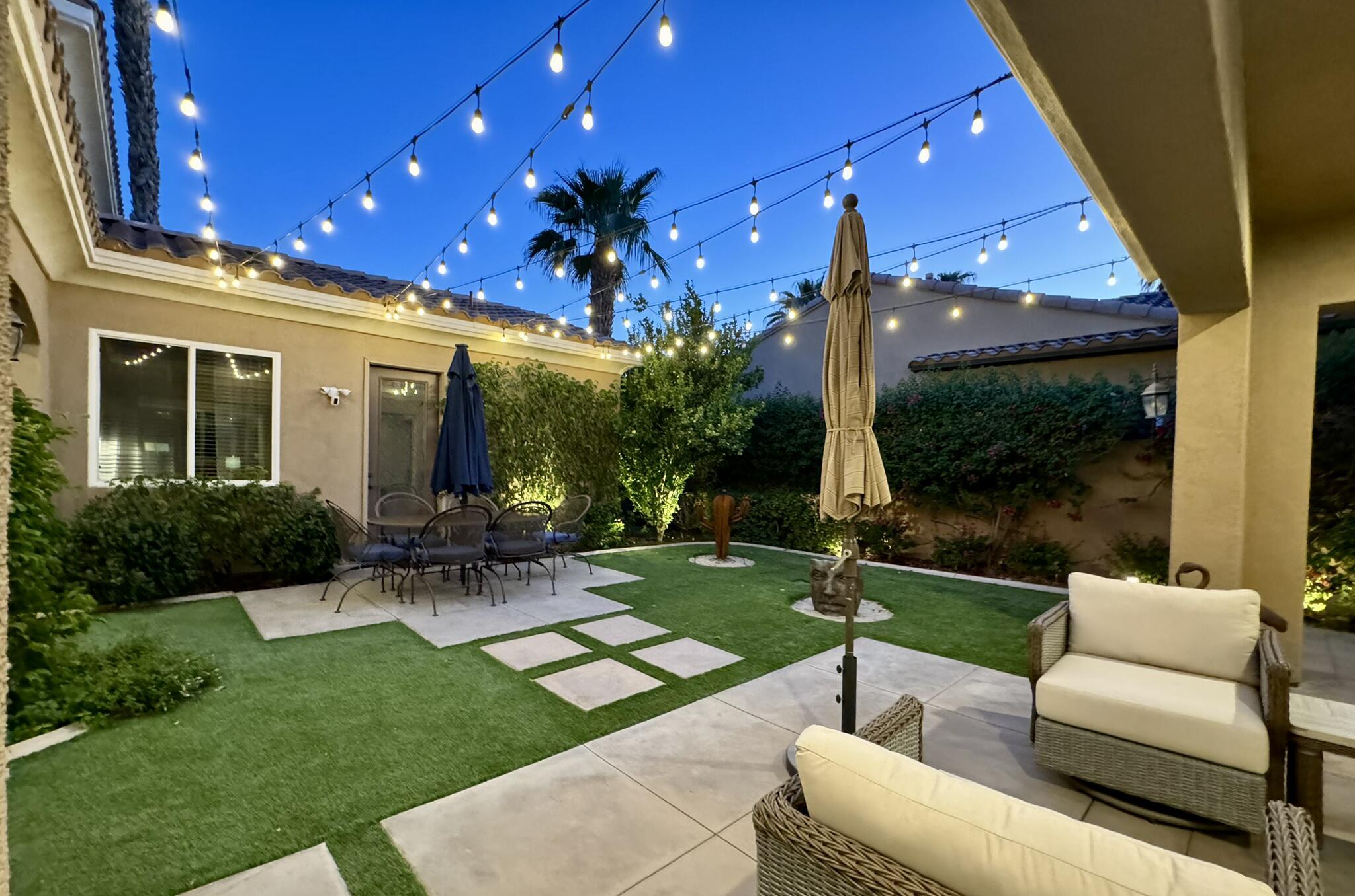 81260 Golf View Drive La Quinta, CA 92253 - Photo 51 of 58 a view of a patio with chairs and a yard
