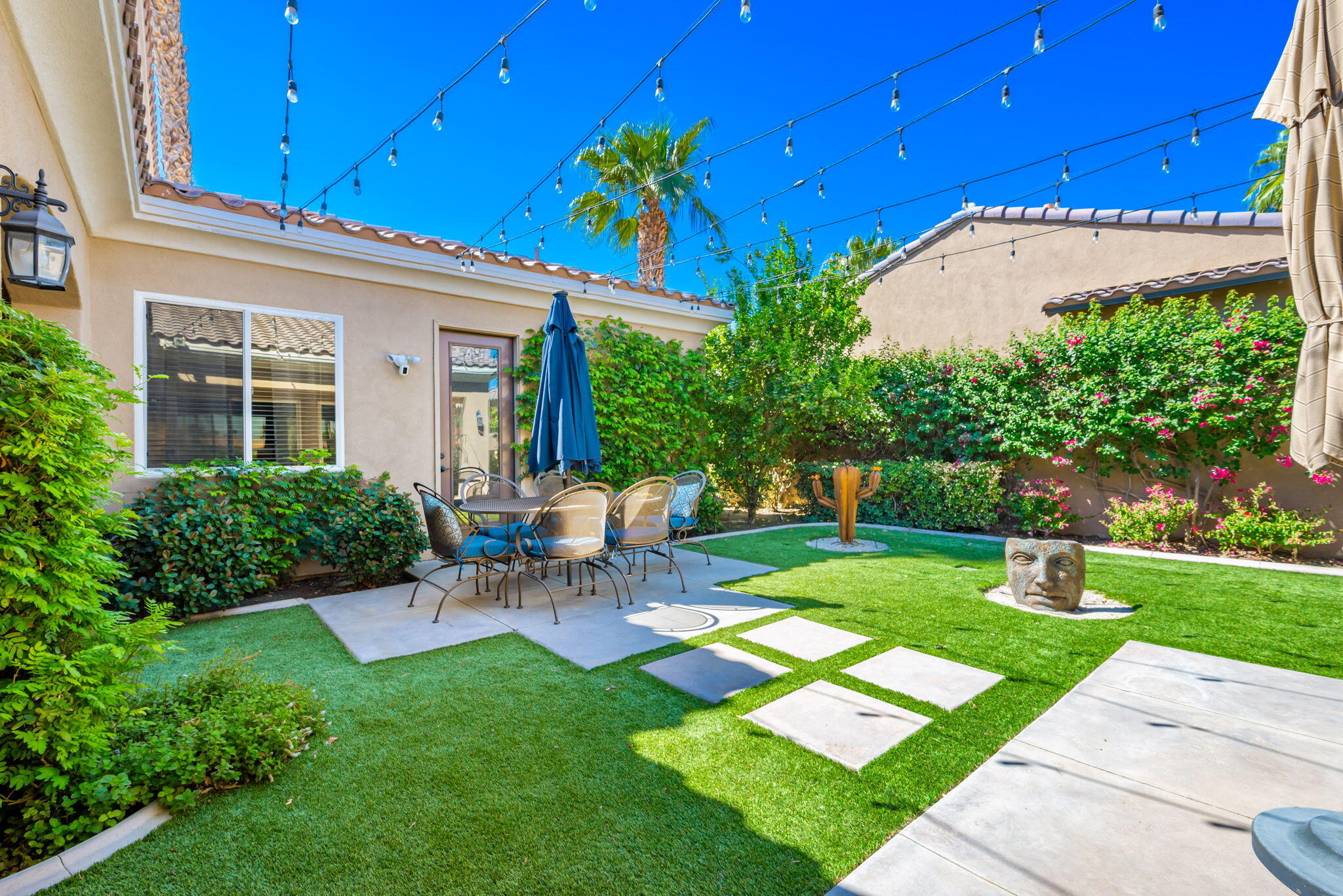 81260 Golf View Drive La Quinta, CA 92253 - Photo 7 of 58 a view of a chair and table in backyard of the house