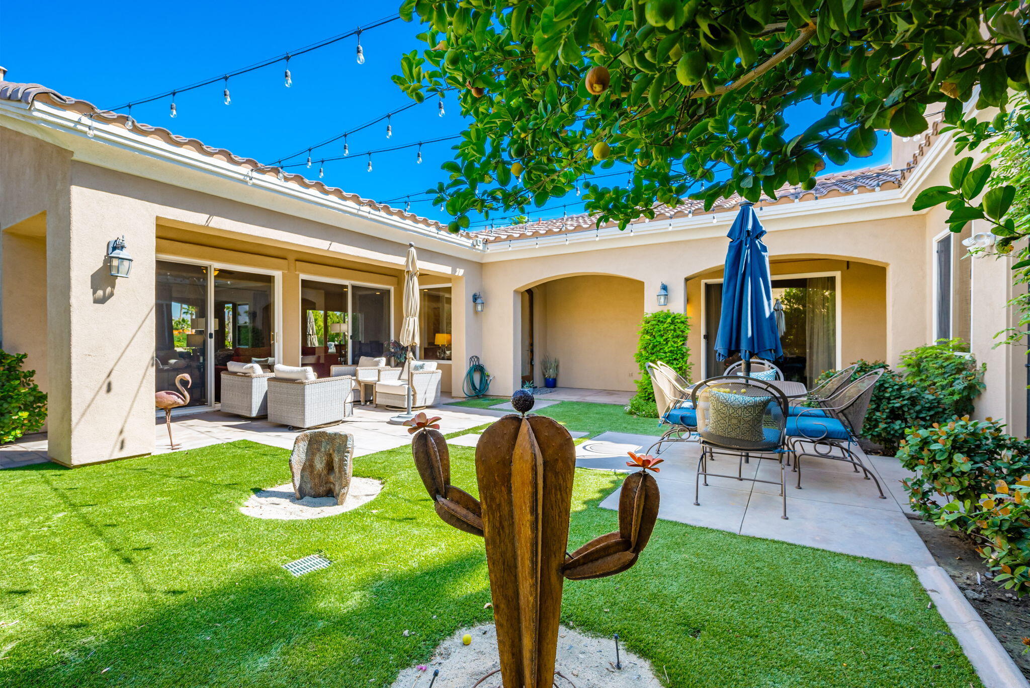 81260 Golf View Drive La Quinta, CA 92253 - Photo 8 of 58 a front view of a house with garden and sitting area