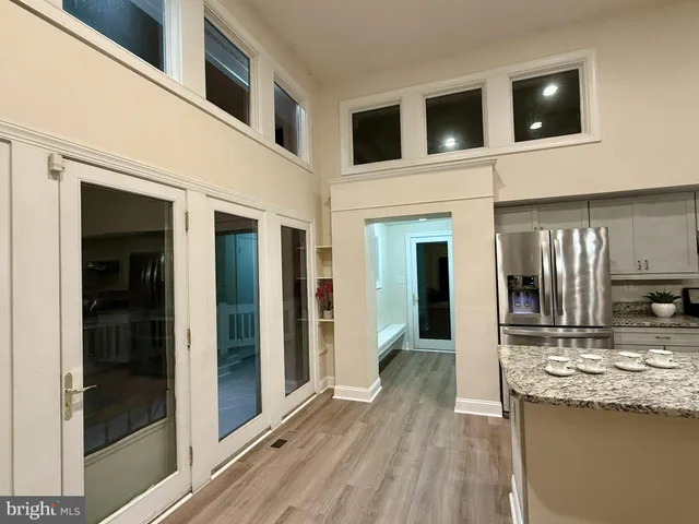 a large kitchen with a large counter top stainless steel appliances and cabinets