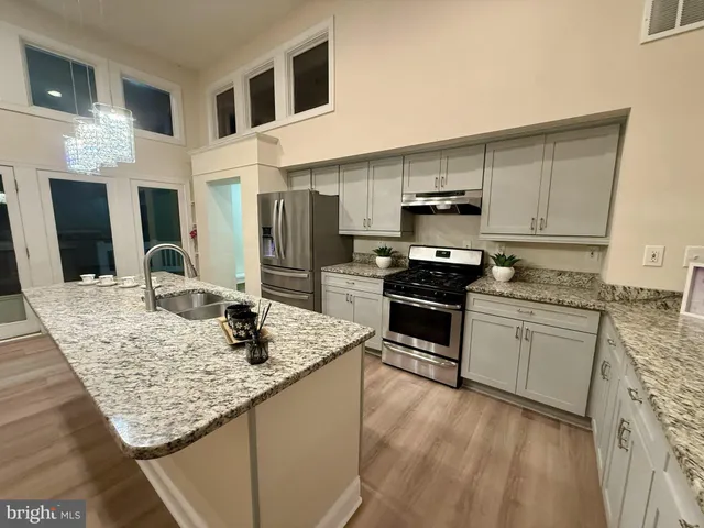 an empty room with wooden floor and a fireplace