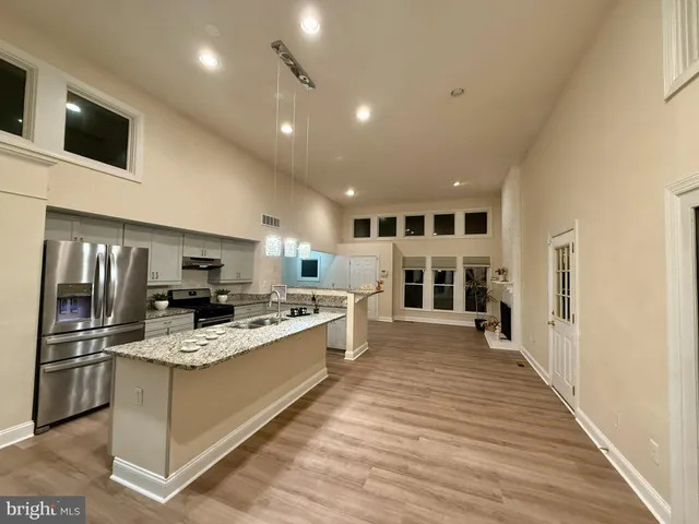 a kitchen with a sink stainless steel appliances and cabinets