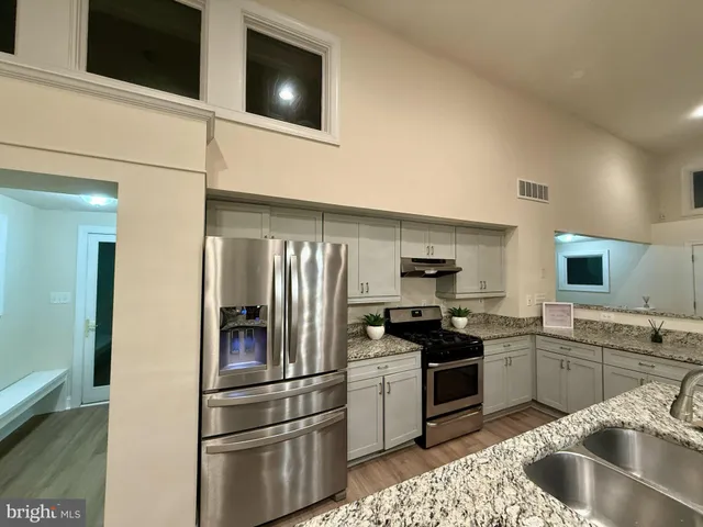 a bathroom with a double vanity sink and a large mirror
