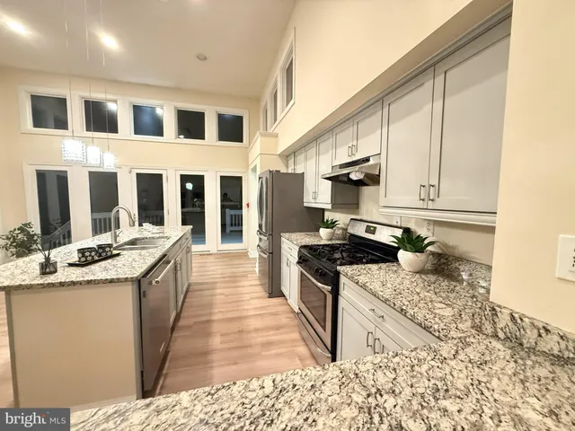 a bathroom with a double vanity sink toilet mirror and bathtub