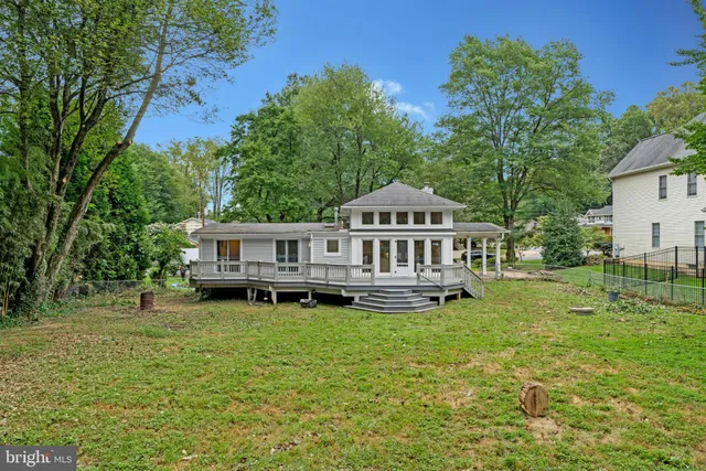 a front view of a house with a yard table and chairs