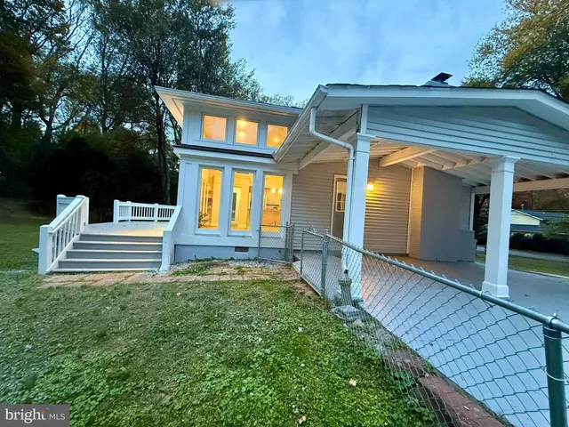 a view of a house with a yard patio and a garden