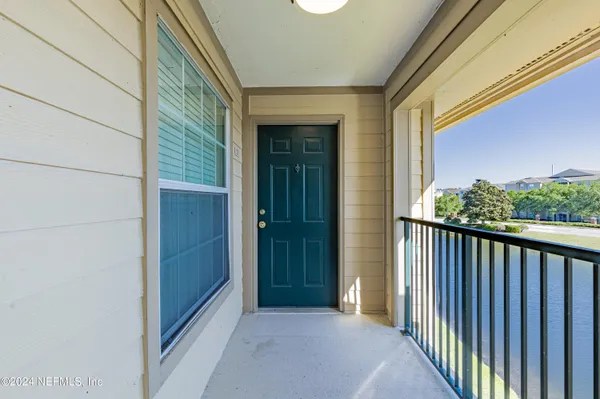 a view of a porch with wooden floor