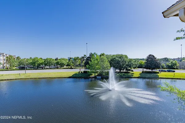 a view of swimming pool with outdoor seating and lake view