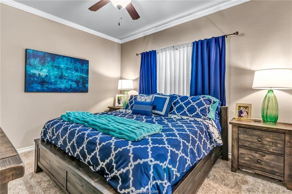 1800 Lonetree Drive College Station, TX 77845 - Photo 11 of 23 a bedroom with a bed and a lamp on dresser