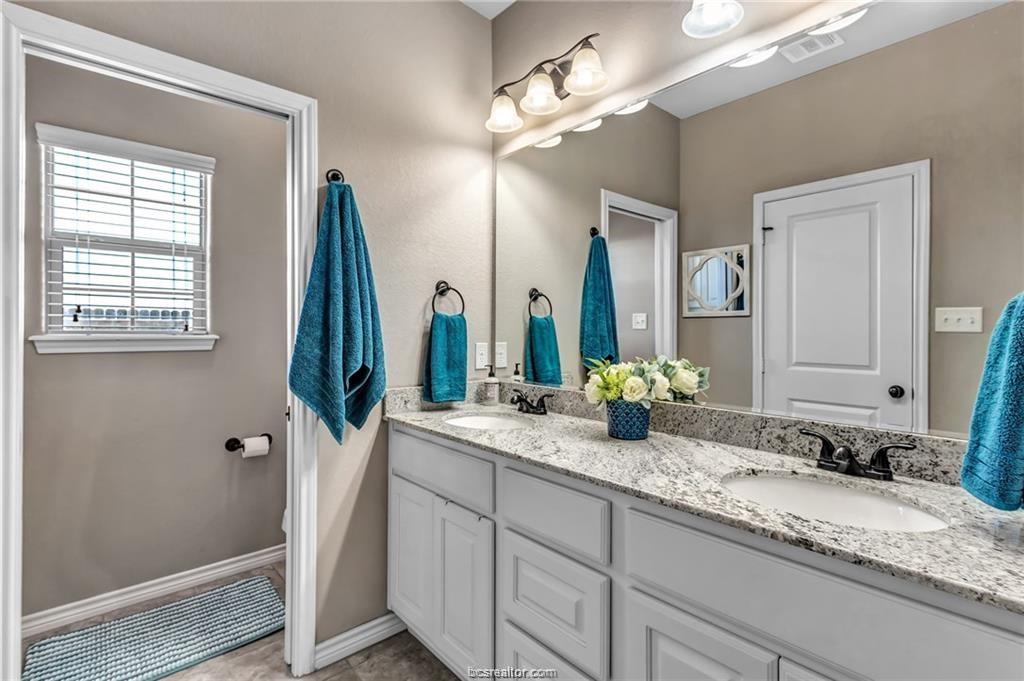 1800 Lonetree Drive College Station, TX 77845 - Photo 13 of 23 a bathroom with a granite countertop sink and a mirror