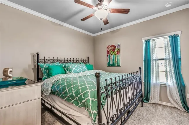 a bed sitting in a bedroom next to a window