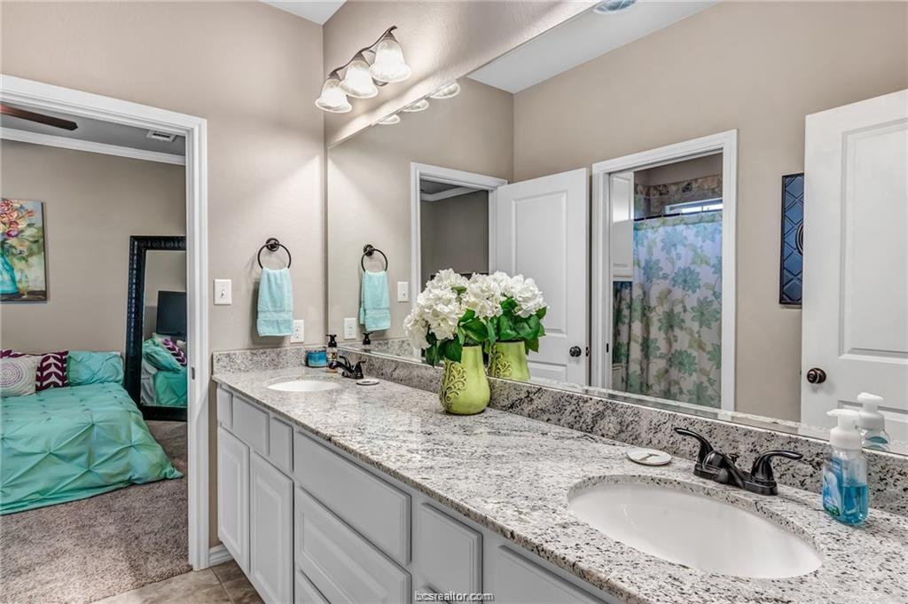 1800 Lonetree Drive College Station, TX 77845 - Photo 17 of 23 a bathroom with a granite countertop sink and a mirror
