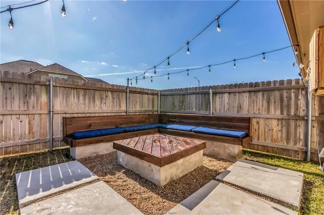 a view of a roof deck with furniture