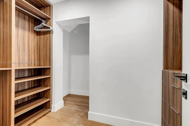 a view of closet area with empty racks