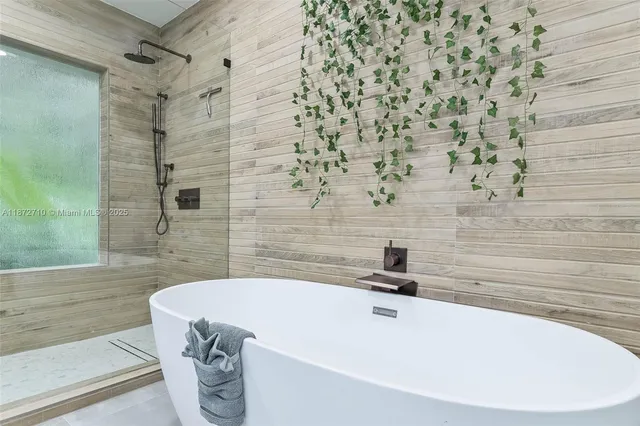 a bathroom with a bathtub and shower